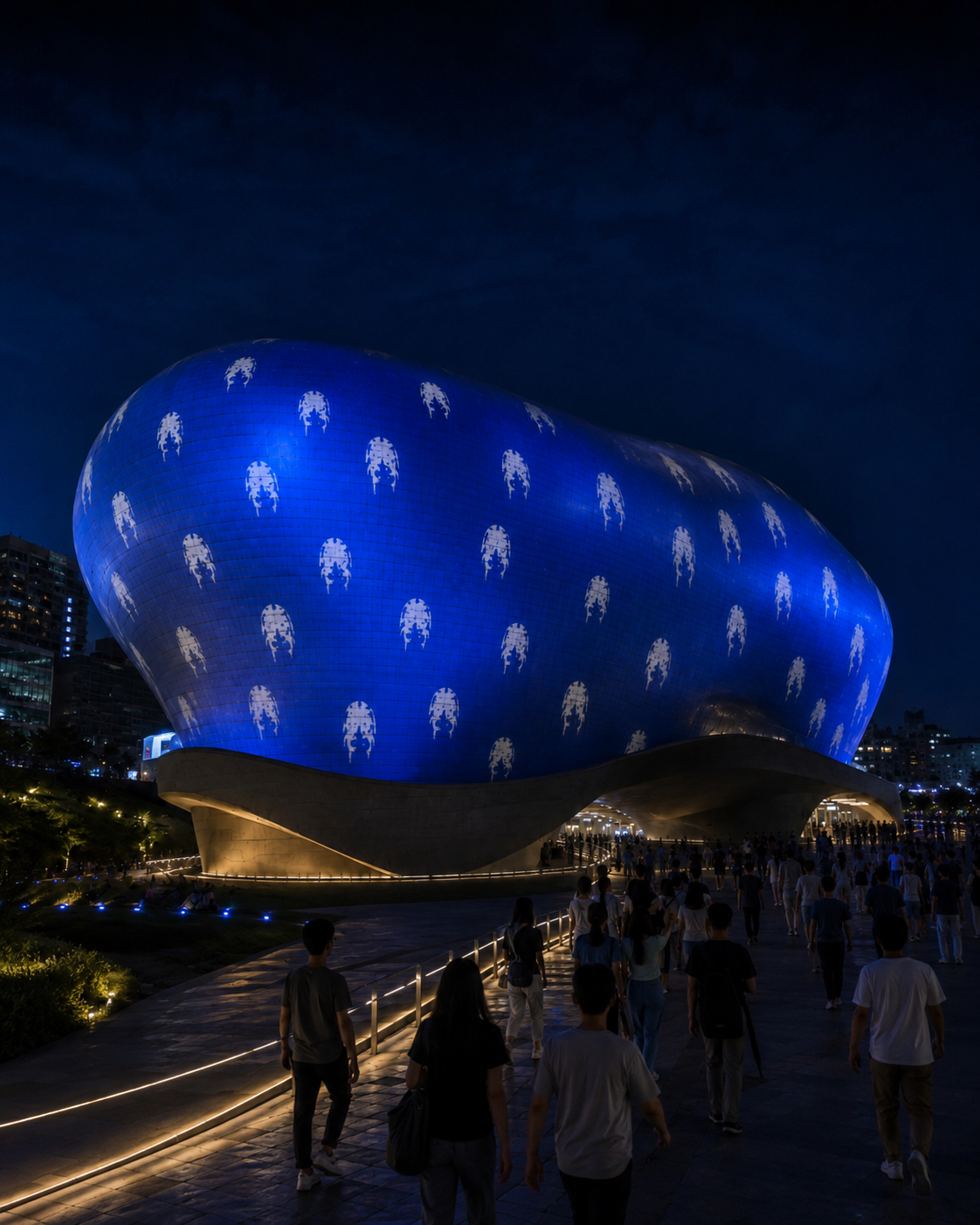 Night view of visitors walking toward the blue Dearly projection at DDP Seoul