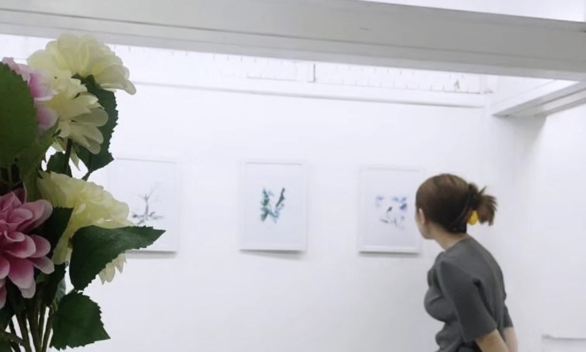 Visitor viewing the REFLECT|ON watercolor exhibition
