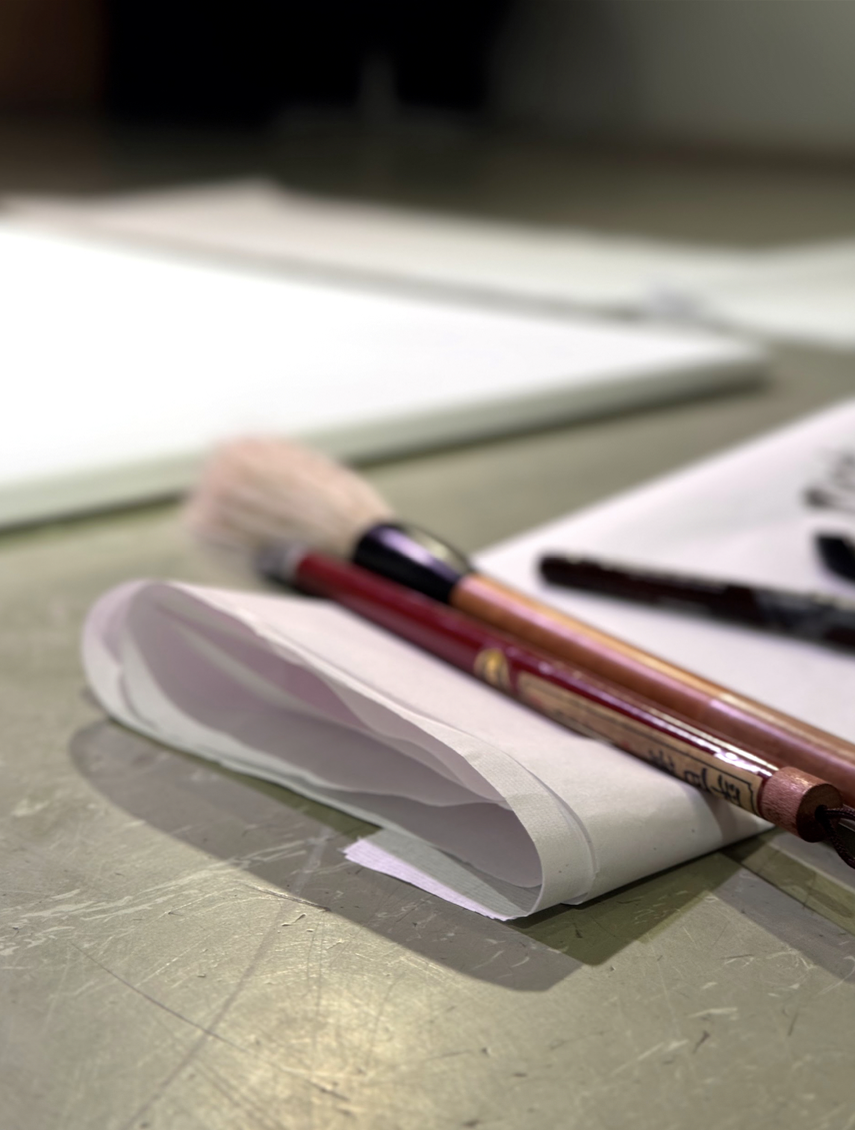 Brushes and folded paper used during the performance