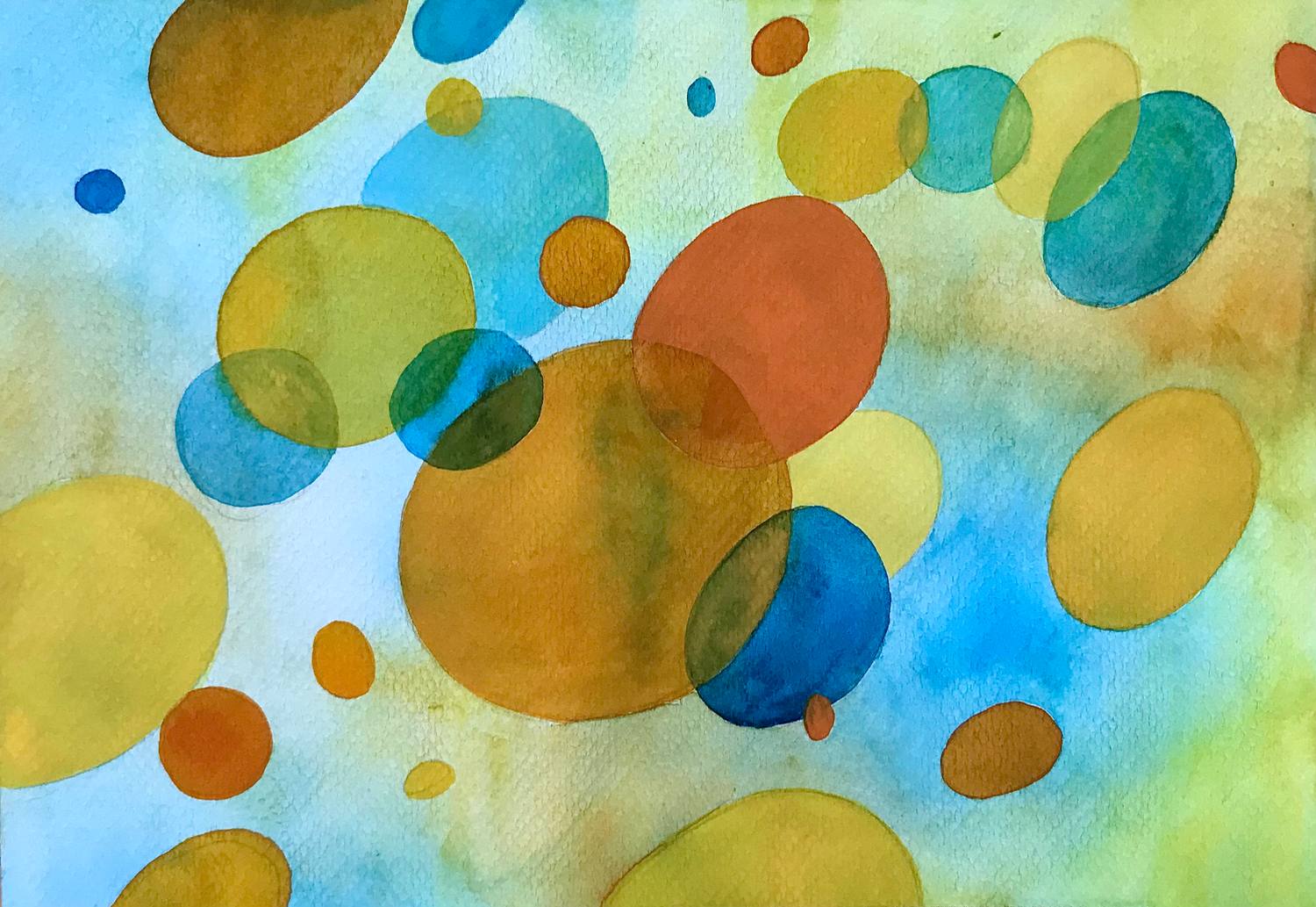 Translucent blue, yellow and orange watercolor circles drifting across paper