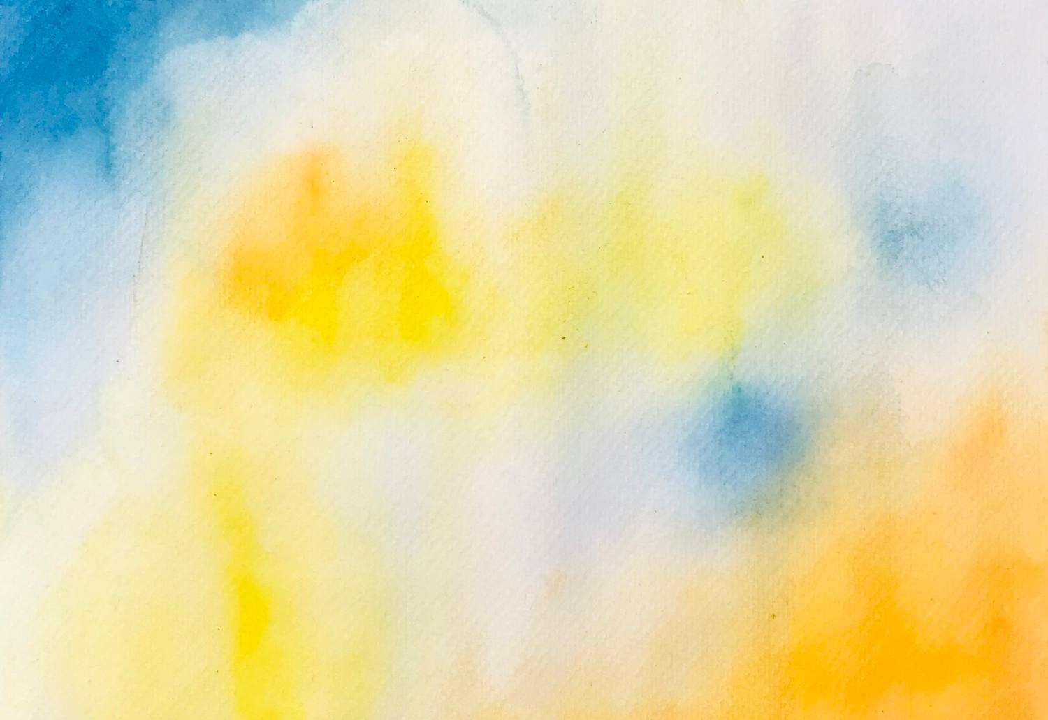 Pale watercolor wash of yellow, blue and orange light