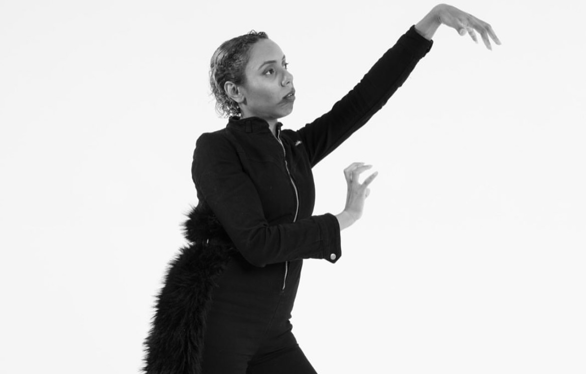 Solo performer shaping the air with raised hands