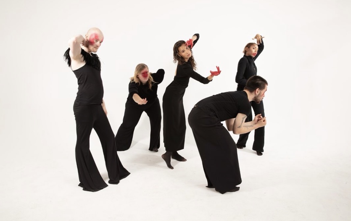 Five performers forming separate expressive poses in the studio