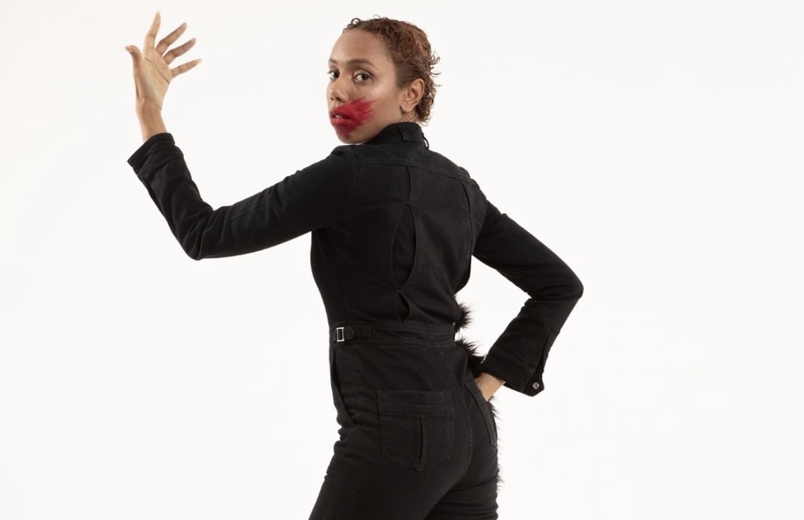 Performer looking back with red makeup across the face