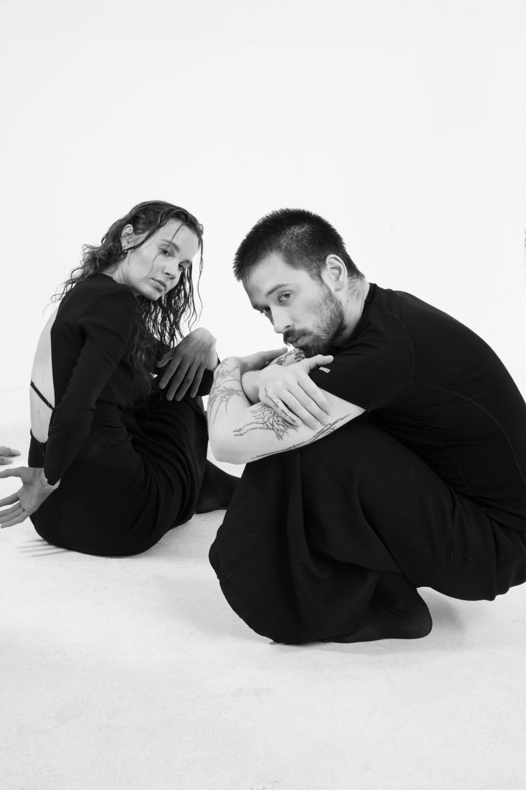 Two performers seated together in the studio