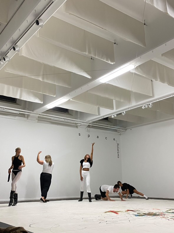 NET 5 performers forming contrasting gestures across the gallery