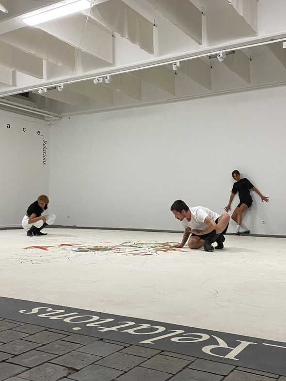 Performers working close to the marked gallery floor